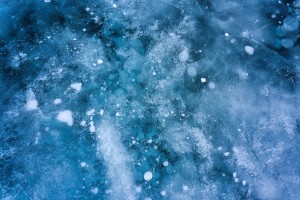 Icy surface of a lake with frozen bubbles